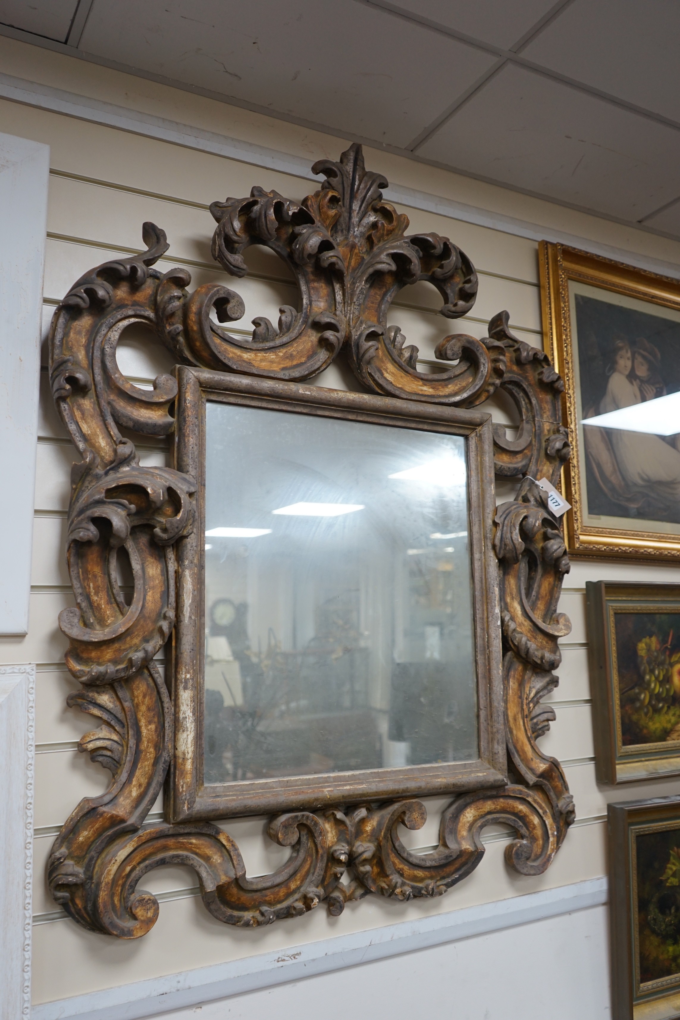 An 18th / 19th century Florentine style carved gilt gesso wall mirror, width 85cm, height 116cm